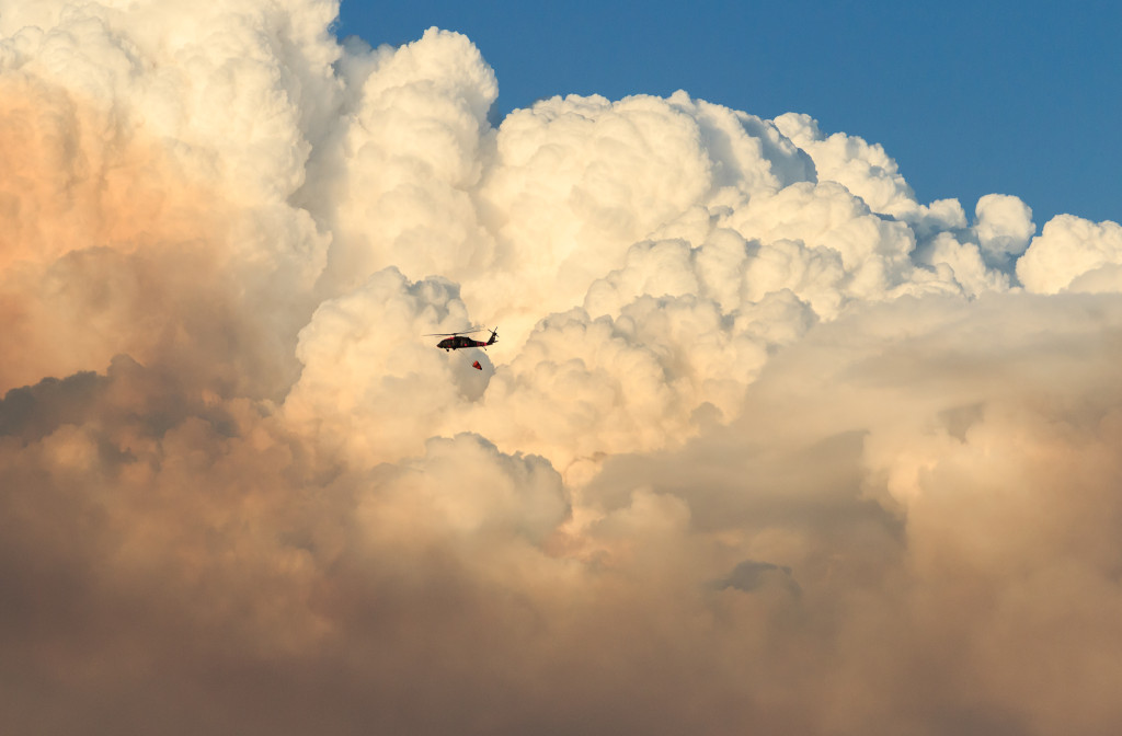 UH-60 Blackhawk helicopter in front of pyrocumulous cloud on Rim Fire, Tuolumne County